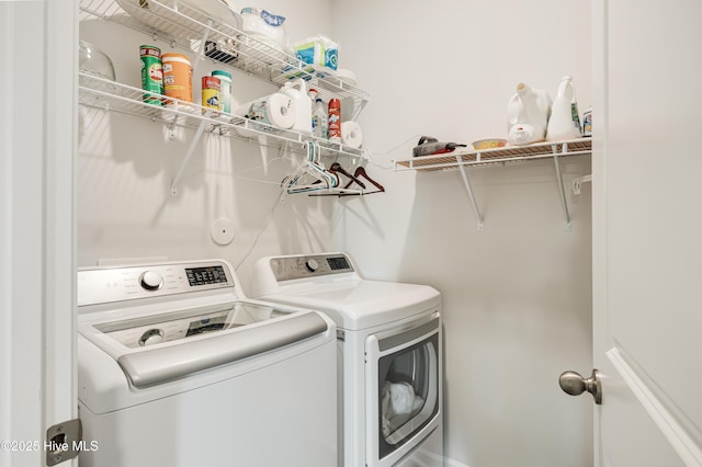 clothes washing area with laundry area and washing machine and clothes dryer