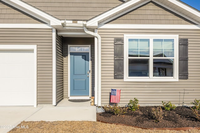 property entrance featuring an attached garage