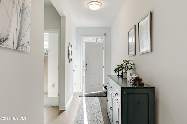 foyer with wood finished floors and baseboards