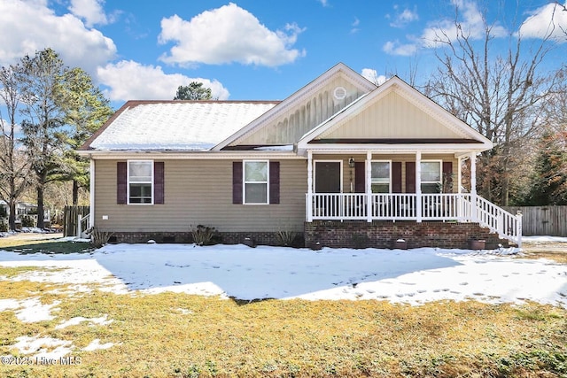 view of front of home with fence and a porch