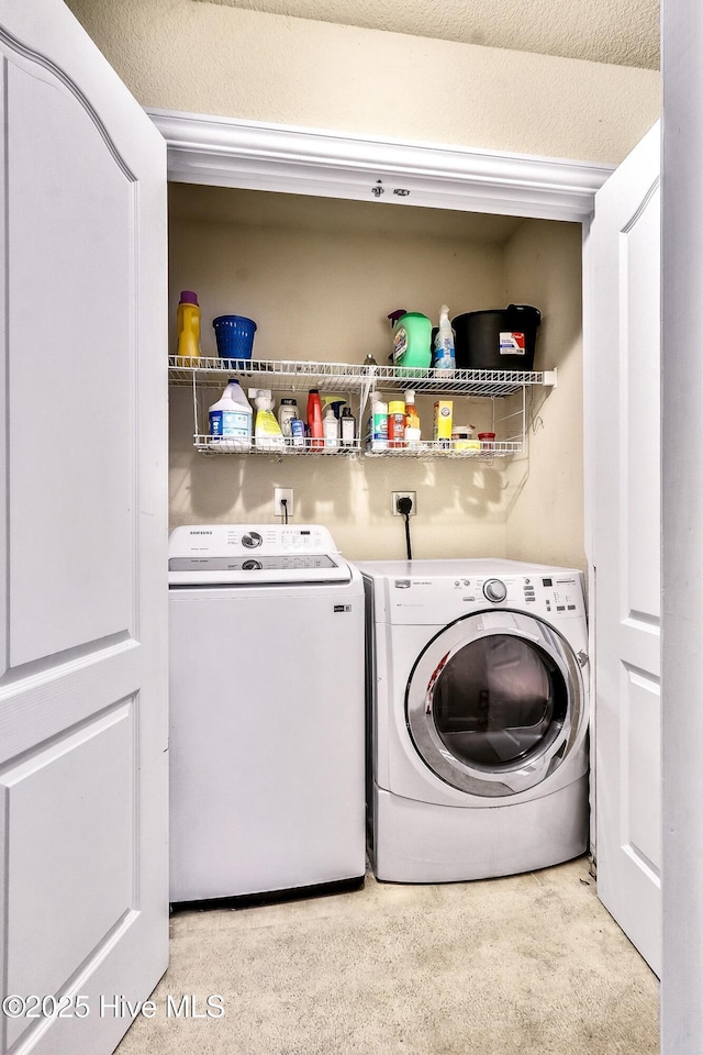 clothes washing area with laundry area and washer and clothes dryer