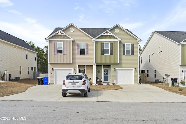 view of front of home featuring a garage, driveway, and central AC unit