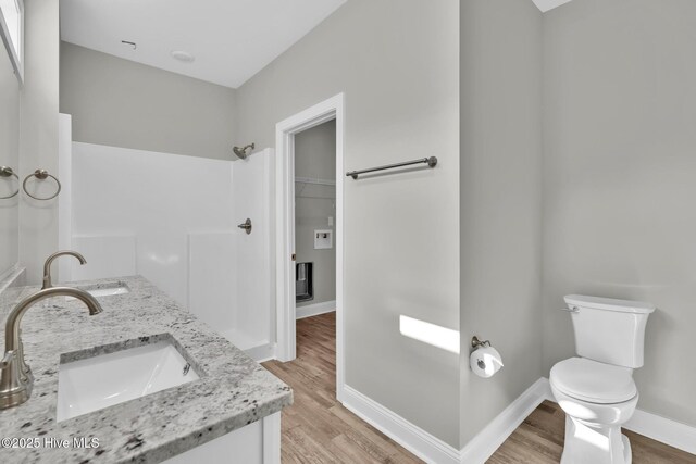 147 NE 18th St, Oak Island, NC 28465 - spacious closet featuring wood finished floors, ceiling fan, and a tray ceiling