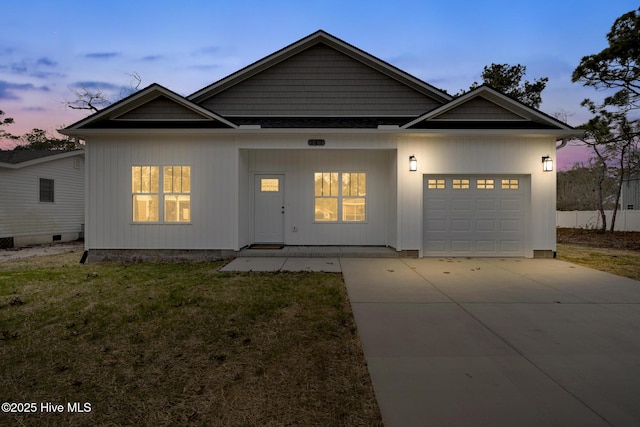 view of front of house featuring a yard, driveway, an attached garage, and a porch