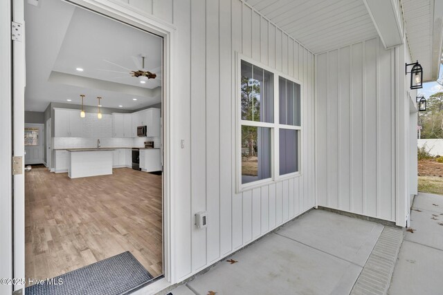 147 NE 18th St, Oak Island, NC 28465 - craftsman-style home with concrete driveway, an attached garage, a porch, and a front lawn
