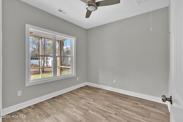 147 NE 18th St, Oak Island, NC 28465 - empty room featuring attic access, ceiling fan, light wood-type flooring, and healthy amount of natural light
