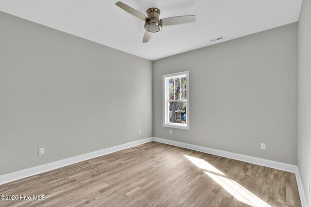147 NE 18th St, Oak Island, NC 28465 - empty room with wood finished floors, baseboards, and ceiling fan