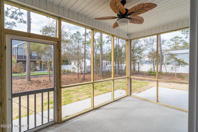 147 NE 18th St, Oak Island, NC 28465 - unfurnished sunroom with a ceiling fan and healthy amount of natural light