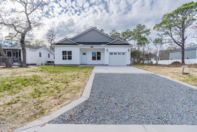 147 NE 18th St, Oak Island, NC 28465 - view of front of home featuring a garage and concrete driveway