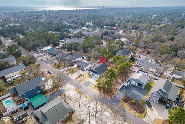 147 NE 18th St, Oak Island, NC 28465 - aerial perspective of suburban area featuring a nearby body of water and a tree filled landscape