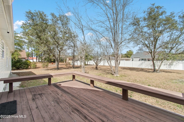 wooden deck featuring a yard and fence