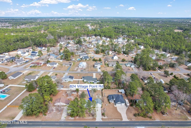 aerial view with a wooded view and a residential view