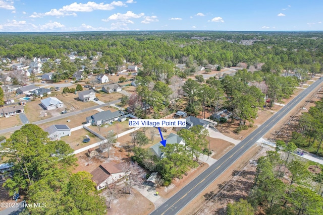 birds eye view of property featuring a residential view and a view of trees