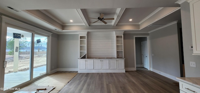 interior space with baseboards, beam ceiling, visible vents, and wood finished floors