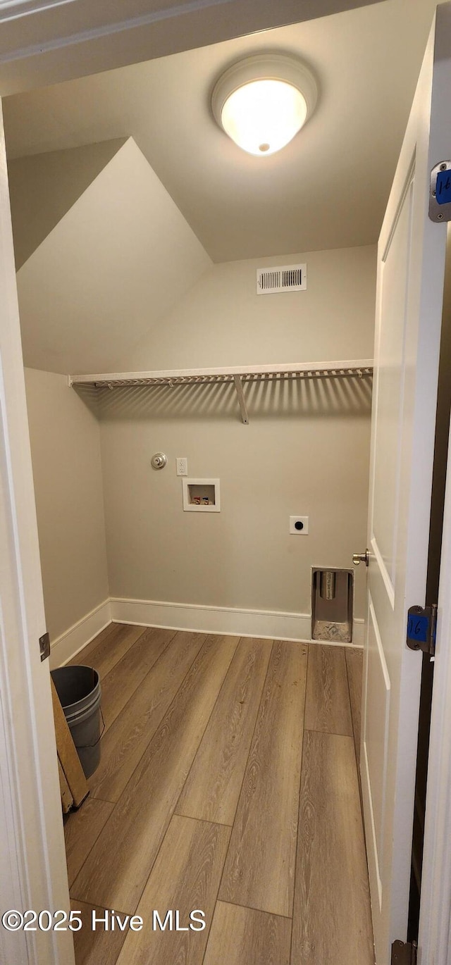 washroom featuring laundry area, visible vents, wood finished floors, hookup for a washing machine, and electric dryer hookup