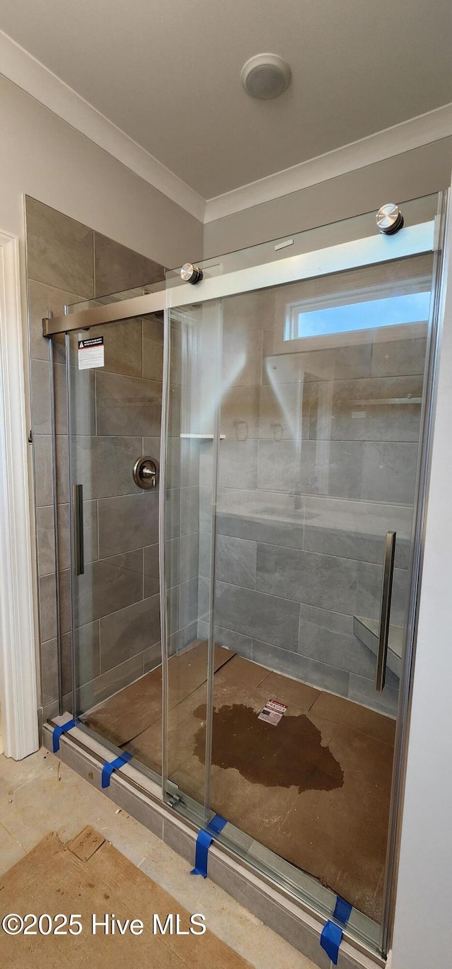 full bathroom featuring ornamental molding and a stall shower