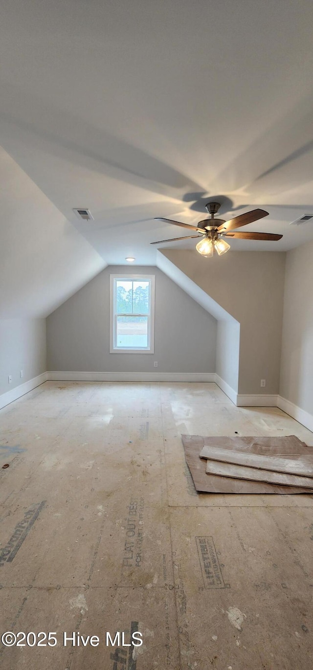 bonus room with ceiling fan, baseboards, visible vents, and vaulted ceiling