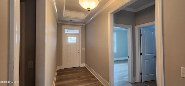 interior space with baseboards, ornamental molding, and dark wood finished floors