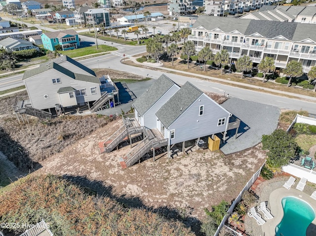 birds eye view of property featuring a residential view, a water view, and a view of the beach