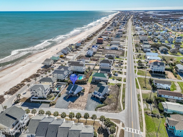 bird's eye view featuring a residential view, a water view, and a view of the beach