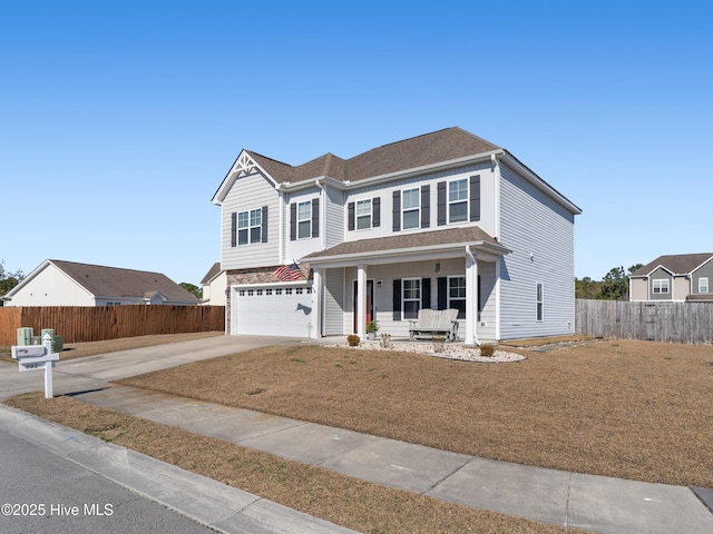 traditional home featuring roof with shingles, a porch, concrete driveway, an attached garage, and fence