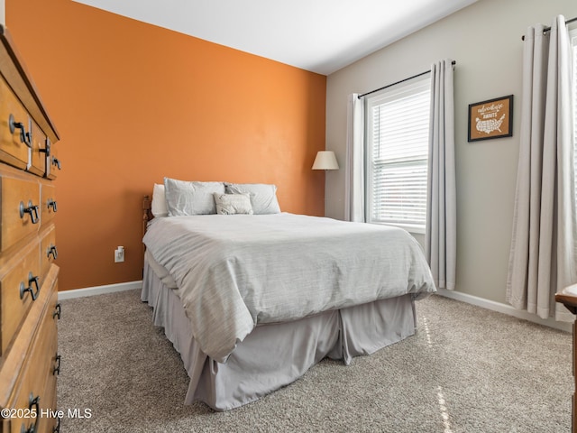 carpeted bedroom featuring baseboards