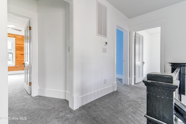 hallway with carpet flooring and visible vents