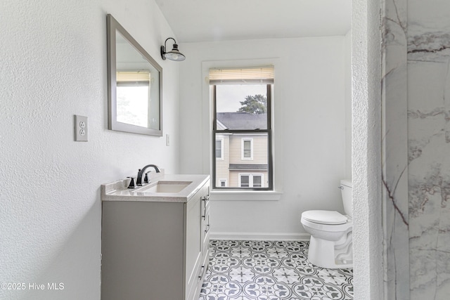 full bath featuring baseboards, a shower, toilet, tile patterned floors, and vanity