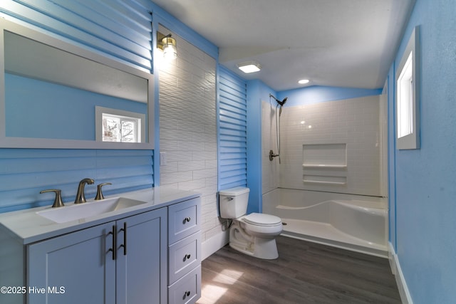 bathroom featuring wood finished floors, vanity, toilet, and walk in shower