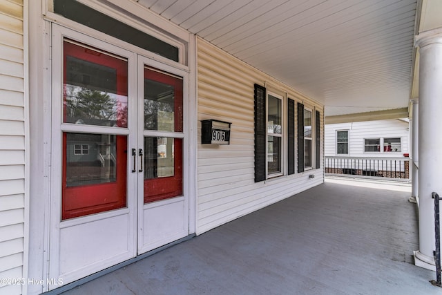 property entrance with a porch and french doors