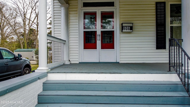 entrance to property featuring french doors and a porch