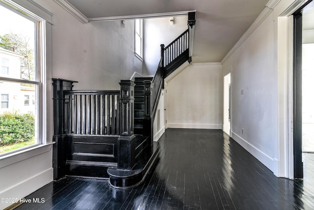 stairs featuring hardwood / wood-style floors, baseboards, and crown molding