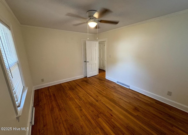 empty room with visible vents, ornamental molding, ceiling fan, wood finished floors, and baseboards