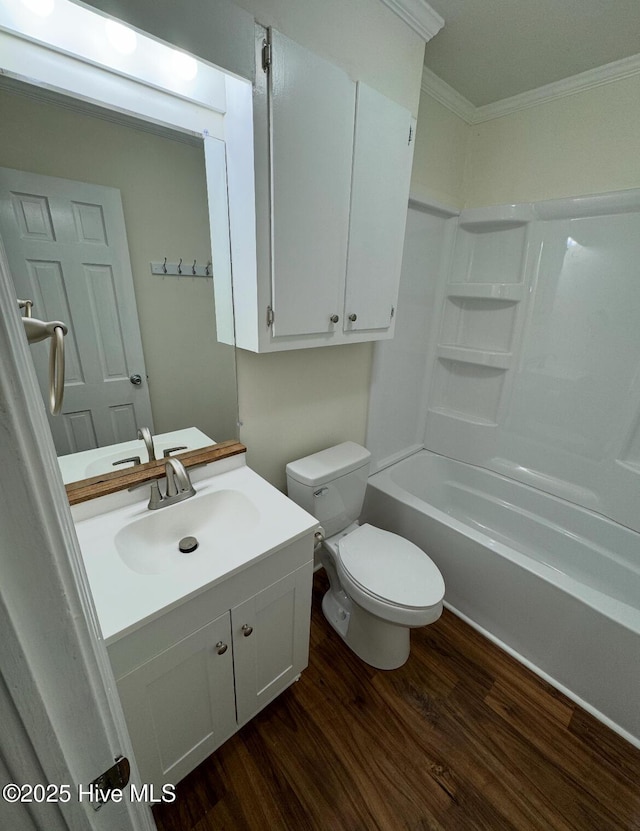 full bath with crown molding, bathing tub / shower combination, toilet, vanity, and wood finished floors