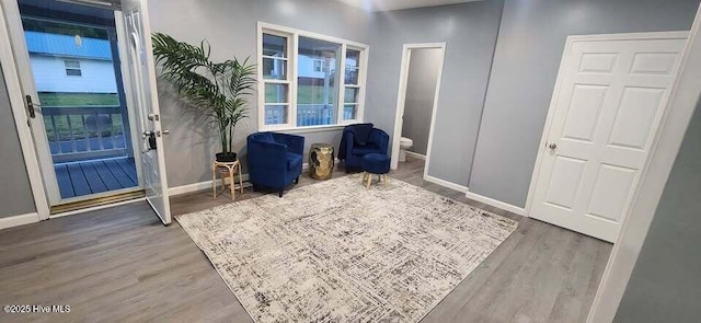 interior space featuring a wealth of natural light, baseboards, and wood finished floors