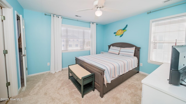 bedroom featuring light carpet, a ceiling fan, visible vents, and baseboards