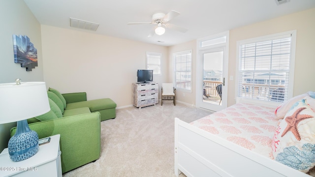 bedroom featuring light carpet, a ceiling fan, baseboards, visible vents, and access to exterior