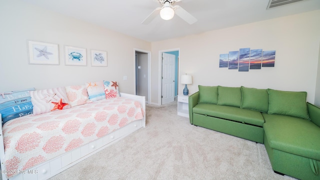 carpeted bedroom featuring a ceiling fan, visible vents, and baseboards