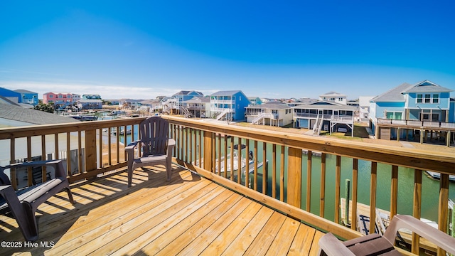 wooden deck featuring a residential view and a water view