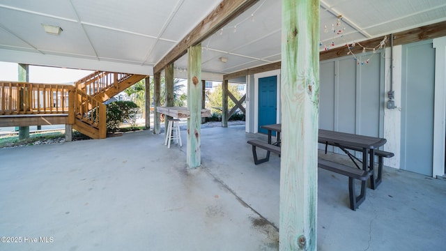 view of patio with outdoor dining area and stairway