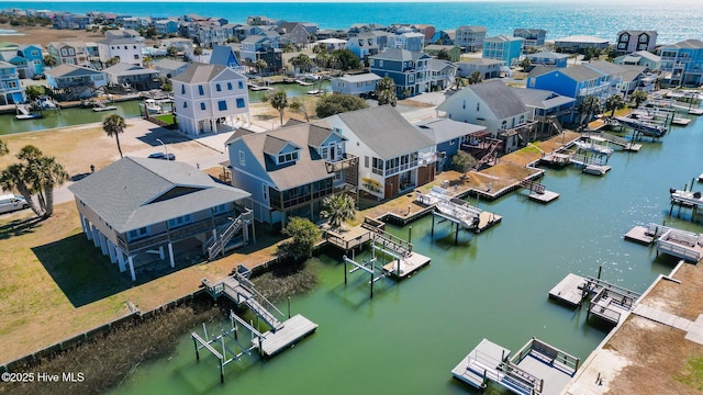 bird's eye view featuring a water view and a residential view