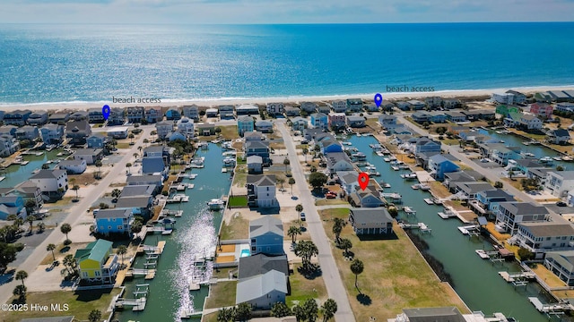 drone / aerial view featuring a residential view and a water view