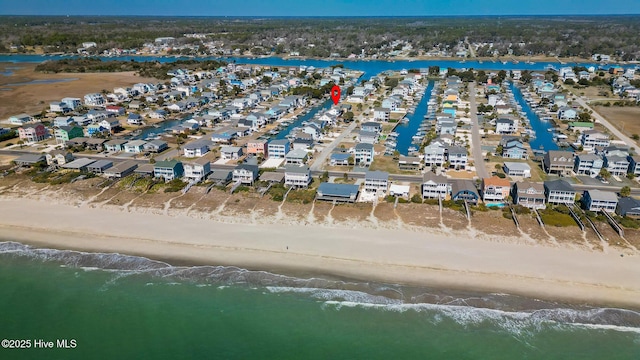 birds eye view of property featuring a view of the beach, a water view, and a residential view