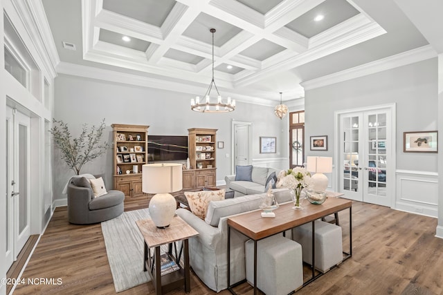 living area with french doors, beamed ceiling, and wood finished floors