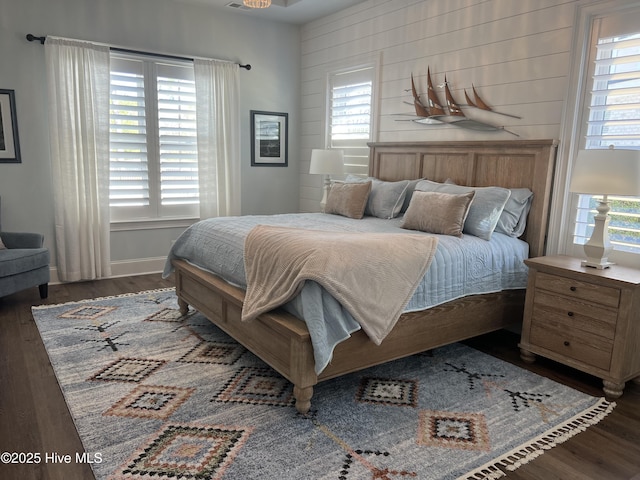 bedroom featuring baseboards and wood finished floors