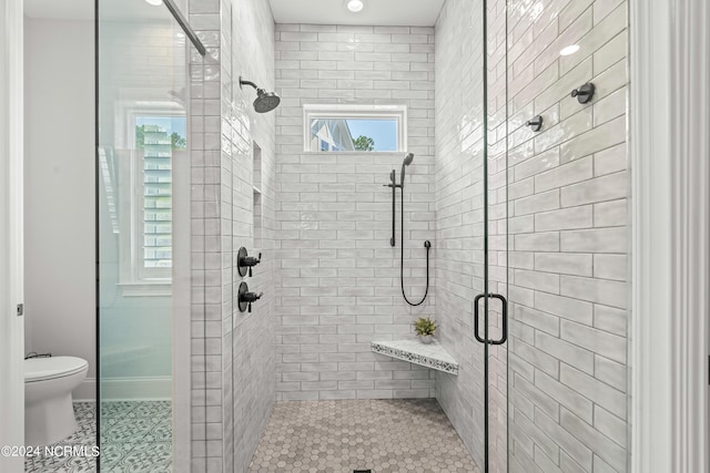 full bathroom featuring tile patterned flooring, a shower stall, and toilet