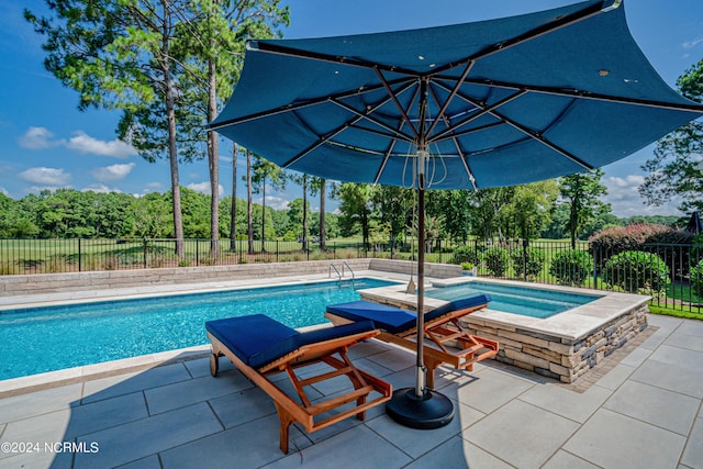 view of pool featuring a fenced in pool, a fenced backyard, a patio, and an in ground hot tub