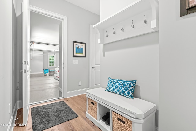 mudroom featuring wood finished floors and baseboards