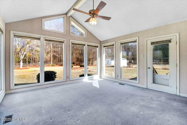 unfurnished sunroom featuring a ceiling fan, visible vents, and lofted ceiling with beams