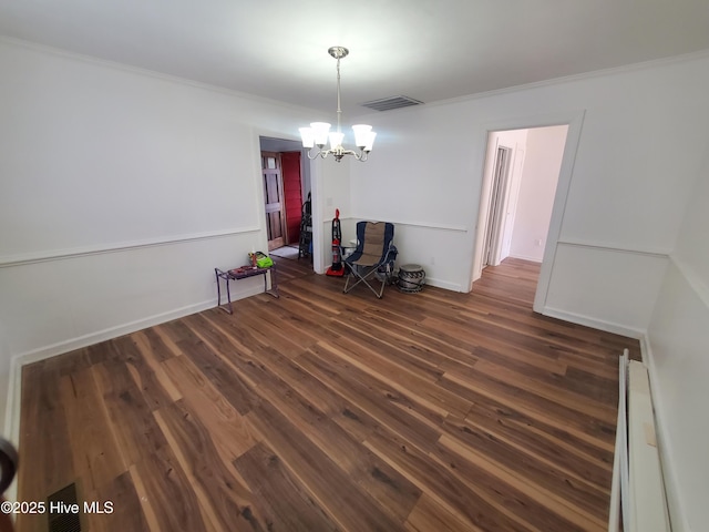 dining area featuring ornamental molding, visible vents, baseboard heating, and wood finished floors